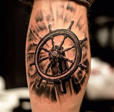 a man's leg with a ship wheel tattoo on it