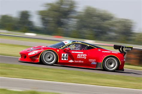 Red Racing Car on Race Track during Daytime · Free Stock Photo