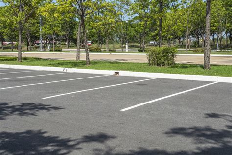 Empty parking lot with trees - XSealer Asphalt Maintenance