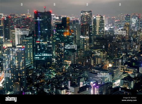 Tokyo skyline at night, with illuminated high skyscrapers Stock Photo ...