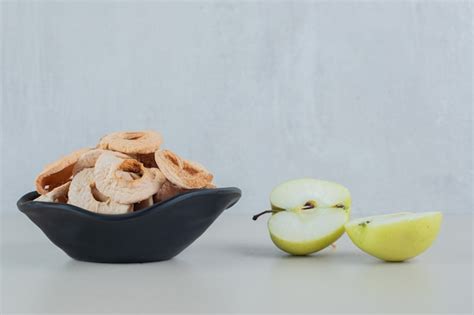 Free Photo | A black bowl full of dried apple fruit with slices of ...