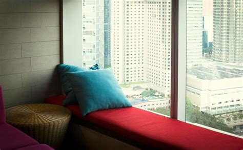 Premium Photo | Cushions with sofa on the windowsill a cozy window sill