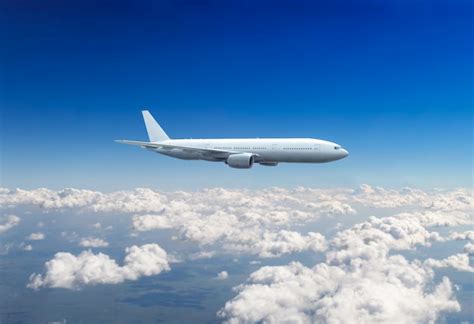 Premium Photo | Commercial passenger plane flying above clouds