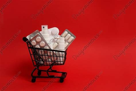 Black shopping cart with pills on red background, copy space