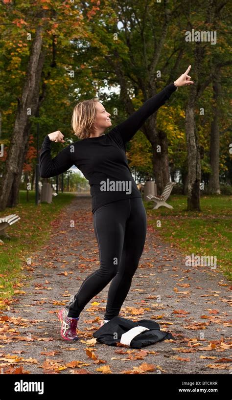 Attractive female athlete doing a victory pose Stock Photo - Alamy