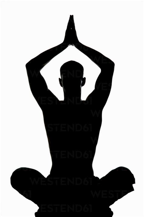 Man exercising yoga, silhouette stock photo