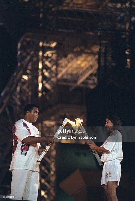 Muhammad Ali and USA swimming athlete Janet Evans carrying torch with... News Photo - Getty Images