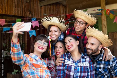 Festa Junina in Brazil, known as brazilian June Party. Group of people in traditional plaid ...