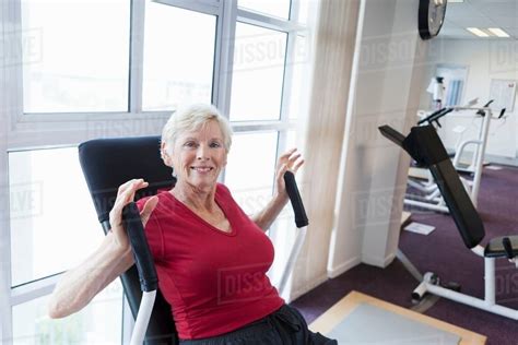 Older woman exercising in gym - Stock Photo - Dissolve