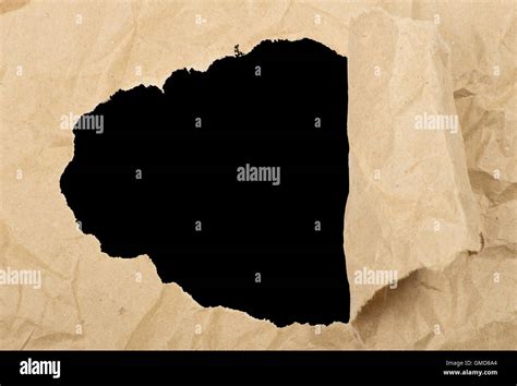 ripped white paper against a black background Stock Photo - Alamy