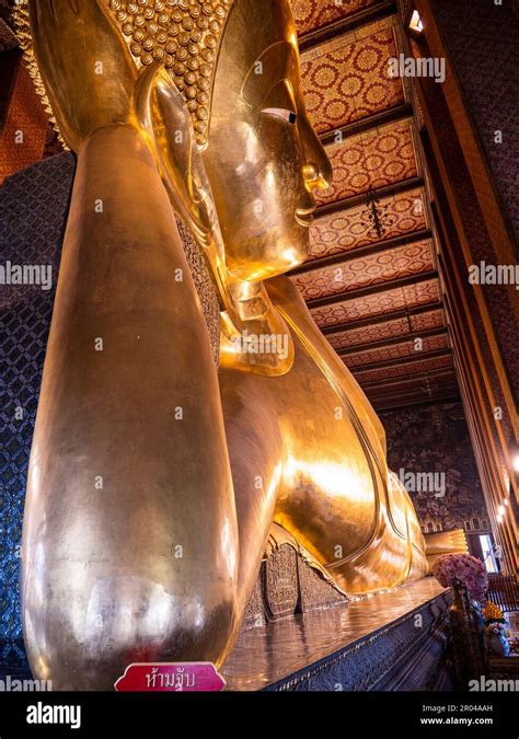 The Reclining Buddha at Wat Pho in Bangkok, Thailand, is a stunning sight. The statue is covered ...