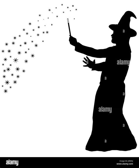 Silhouette of a bearded wizard in cloak with pointed hat creating magic Stock Photo - Alamy