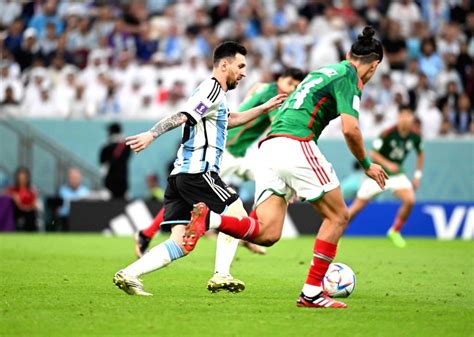 :Lusail:Argentina's Lionel Messi, dribbles past Mexico's Erick Gutierrez.