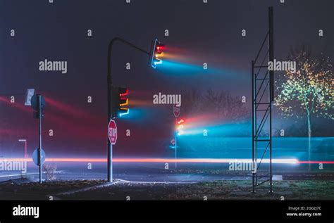 Street lights on the foggy street at night Stock Photo - Alamy