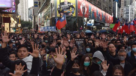 Thousands march as Hong Kong protests near half-year mark