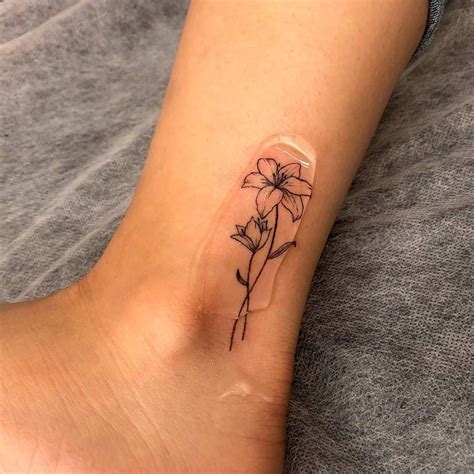 Fine line lily flower tattoo on the ankle. | Lillies tattoo, Tattoos, Petite tattoos