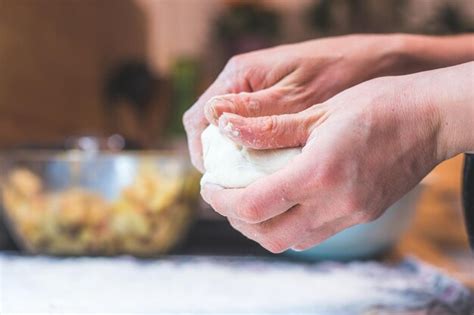 Premium Photo | Kneading traditional dough in the kitchen close up