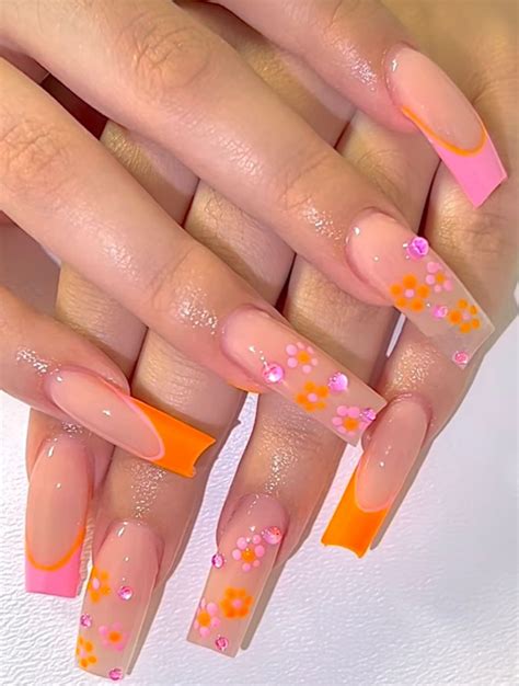 Experience the explosion of neon orange nails