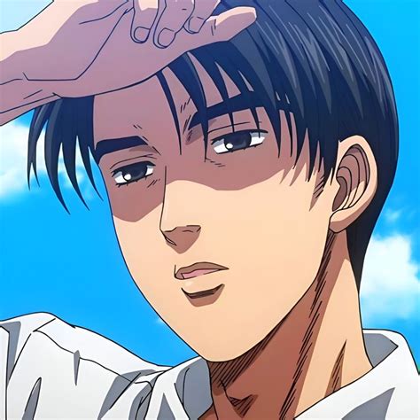 a man with black hair and blue eyes is holding his hand up to his head