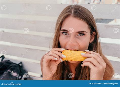 Woman Eats Corn on Beach. Vegetarian Hipster Woman Eat Fresh Organic ...