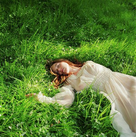 Woman In Dress Lying Down On Grass by Lisa Kimmell