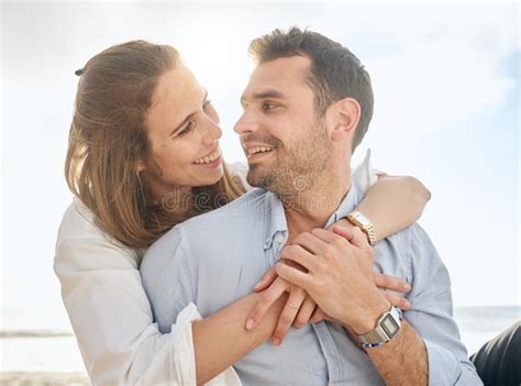 Love, Couple and Hug on a Beach at Sunset, Loving and Romantic while Bonding on Vacation. Happy ...