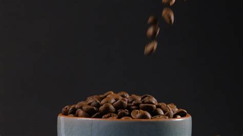 Slow motion of roasted coffee beans falling. Organic coffee seeds. 10309814 Stock Video at Vecteezy