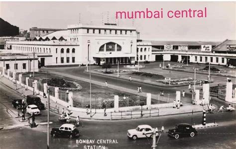 an old black and white photo of a building with cars parked in front of it