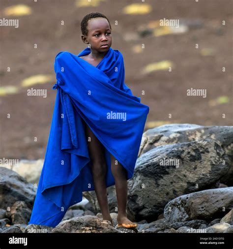 Turkana boy. Young boy from a Turkana tribe wrapped in a blanket. The Turkana people are an ...