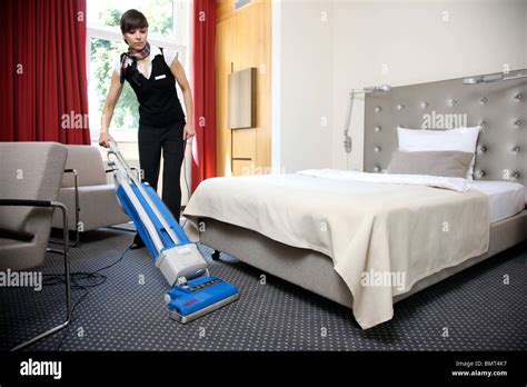 Hotel, room service, house keeping at work in a hotel room. Cleaning up, making the beds Stock ...