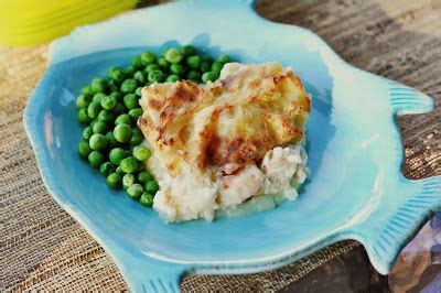 a blue plate topped with mashed potatoes and peas