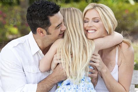 Girl Child Hugging Happy Parents In Park or Garden 854548 Stock Photo at Vecteezy