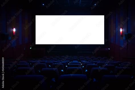 Empty cinema auditorium with empty white screen. Empty rows of theater ...