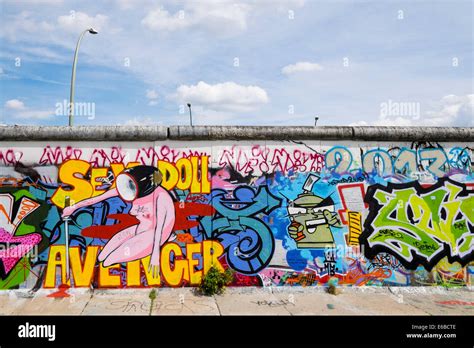 Graffiti on original section of Berlin Wall at East Side Gallery in Friedrichshain in Berlin ...