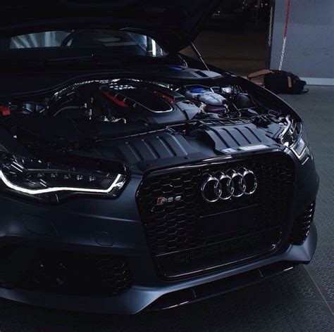 an audi car with its hood open and the engine in it's center compartment