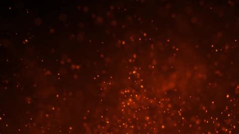 Fire ember dust sparkling across frame in front of red gradient background Slow Motion | ClipStock