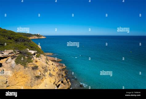 Cala de roca Plana beach in Tarragona beside Waikiki beach also Cala Fonda Stock Photo - Alamy