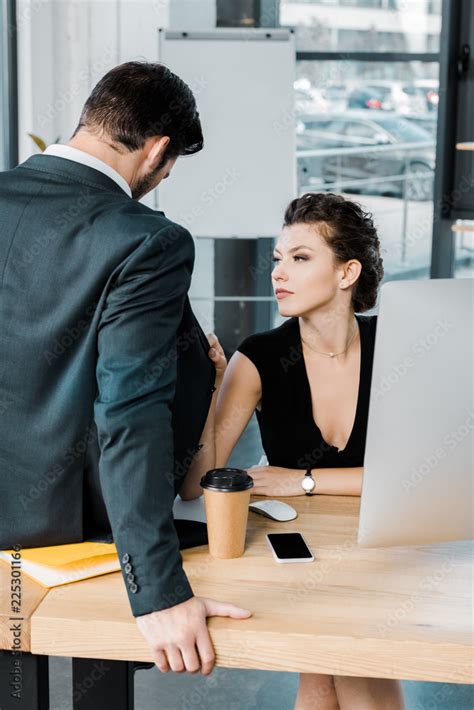 young seductive businesswoman flirting with colleague at workplace in office Stock Photo | Adobe ...