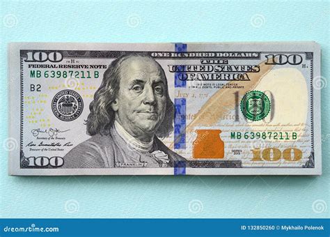 US Dollar Bills Of A New Design With A Blue Stripe In The Middle Is Lies On A Light Blue ...