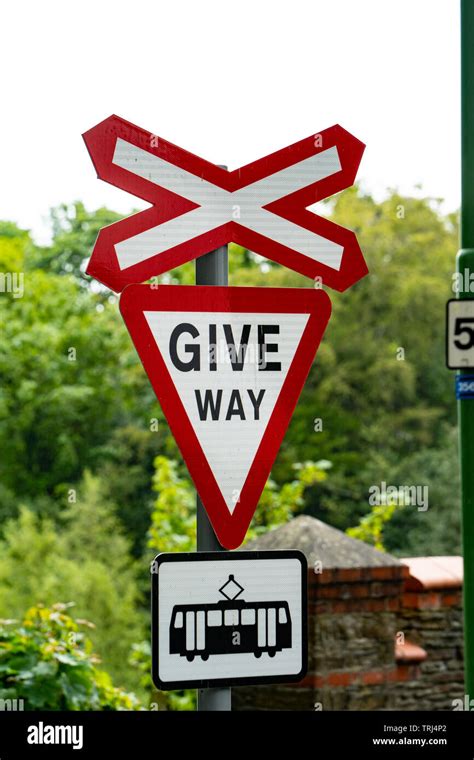 Sign for Give Way to trams, level crossing sign, Laxey, Isle of Man, UK Stock Photo - Alamy