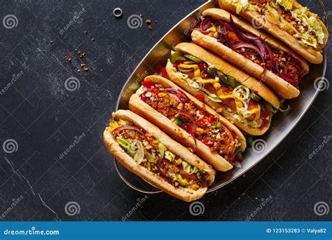 Hot Dogs Fully Loaded with Assorted Toppings on a Tray. Stock Image ...