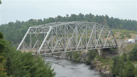 Driving Across A Truss Bridge That Crosses The Pic River. Footbridge On Right And Bridge Under ...