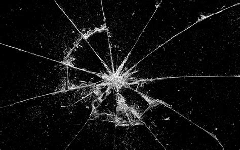 Broken glass, black background, cracks in the glass, cobwebs on the ...