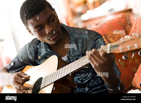 black african teenage boy playing guitar Stock Photo - Alamy