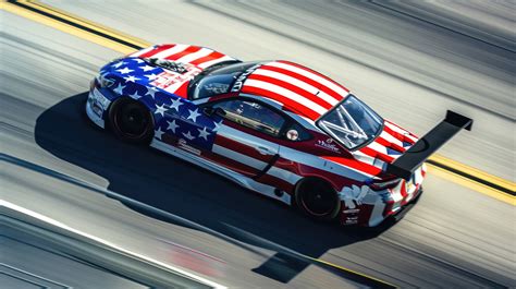 American flag racing car, patriotic car design, race track speed blur, high-speed racing, Stars ...