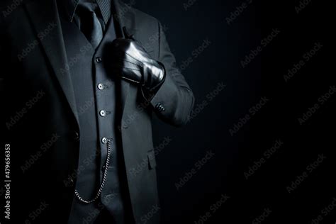 Portrait of Mysterious Man in Dark Suit and Leather Gloves on Black Background. Vintage Style ...