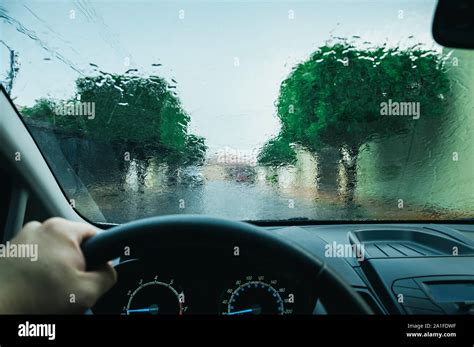 Windshield of a car wet by the rain. Driving a car on a rainy day ...