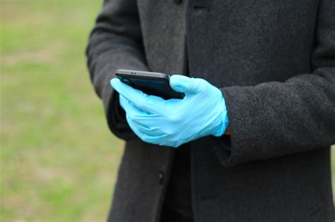 Premium Photo | Hands of a man in medical gloves for protection from COVID-19