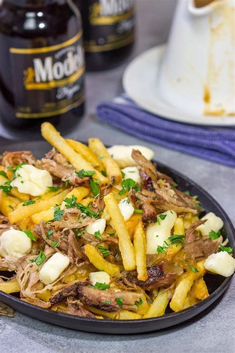 Pulled Pork Poutine | Fries topped with gravy + cheese curds + pulled pork!