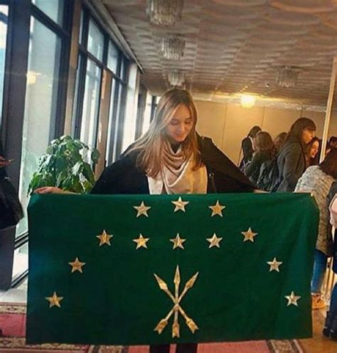 Circassian girl holding the flag of Circassia | Adygea, Culture, History